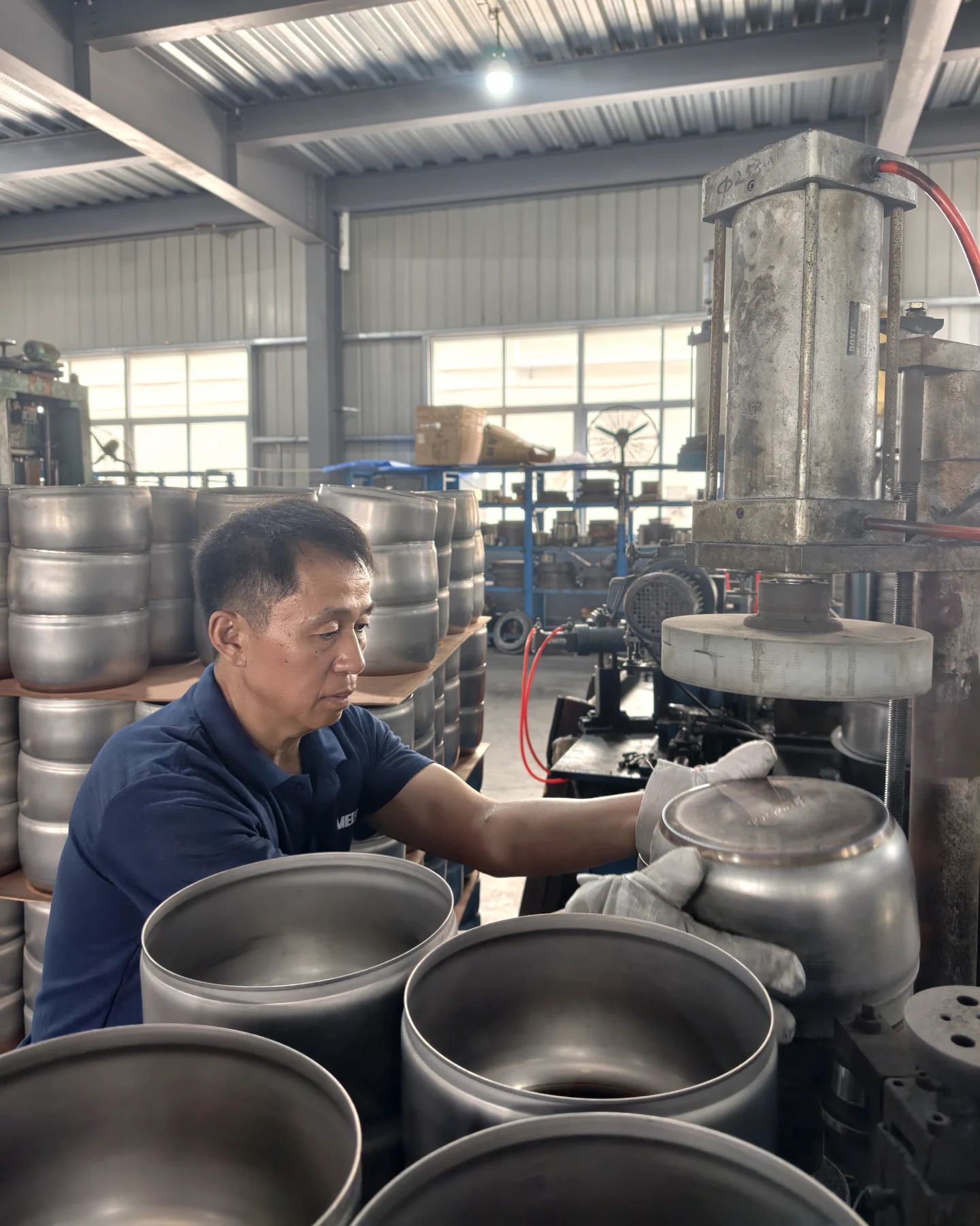ANMEI worker operating cookware production equipment